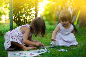 Girls having fun painting in the garden, together concept, famil